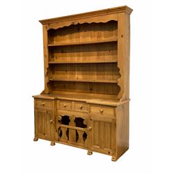 20th century pine dresser, the projecting cornice over three height plate rack, inverted break front fitted with four drawers over two cupboards and a storage space with a lift out division W156cm, H210cm, D49cm 