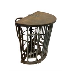 A cast iron turnstile from York City football ground by Ellison & Co., Manchester, painted green with crowed counter with brass plate H104cm, W110cm, D104cm 