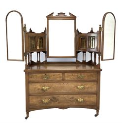 Late Victorian figured walnut dressing chest, two bevel glazed cupboards with arched swing mirrors raised on spindle galleries, two short and two long drawers under, raised on turned supports terminating in brass and ceramic castors, W122cm