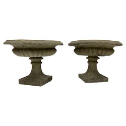 Pair of Victorian design squat garden urns, egg and dart border over narrow neck and gadrooned underbelly, turned and fluted stem on square foot