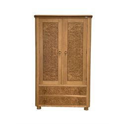 Bespoke light oak double wardrobe with figured burr oak doors enclosing two shelves, two drawers under, raised on turned supports W109cm, H179cm, D70cm