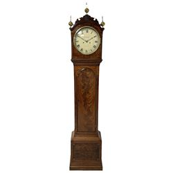 Grimalde of London – Mahogany 8-day longcase clock c1805, with a break arch scroll carved pediment and three ball and spire finials, hood with canted and reeded corners and hinged cast brass bezel, rectangular trunk with a long brake arch topped door and cavetto moulding to the edge, stepped plinth with applied beading to the front, painted circular dial with Roman numerals, minute track and finely pierced matching steel hands, dial pinned directly to a five pillar rack striking movement with a recoil anchor escapement, striking the hours on a bell. With pendulum and brass cased weights.
Peter & Samuel Grimalde are recorded as a 19th century London clock and chronometer makers.
