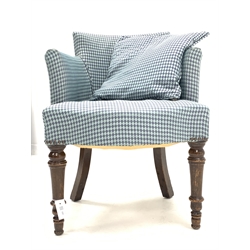 Early 20th century tub shaped armchair, upholstered in blue fabric with lozenge pattern, raised on turned front supports