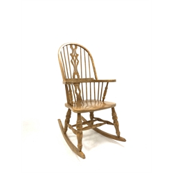 20th century elm Windsor style rocking armchair, hoop back with spindles and pierced splat over saddle seat and turned supports united by double 'H' stretcher, W65cm