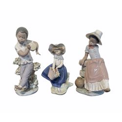 Pair of Lladro figures designed by Jose Roig 'Bongo Beat' No5157 and 'A Step in Time' No.5158 and a Lladro figure of a girl with a basket of flowers.