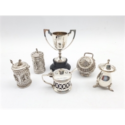 Indian white metal mustard pot and pepperette embossed with figures, similar cauldron salt and cover with embossed foliage and serpent handle, English silver mustard pot, pepperette and a small challenge cup