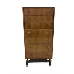 G-Plan - mid 20th century teak chest, fitted with seven drawers, brass loop handles, raised on an ebonised base 