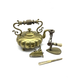19th century small brass smoothing or lace box iron with trivet, a 19th century sleeve iron with carved bone handle, Thackray of Leeds Tracheotomy tube introducer, sand timer and a Victorian brass kettle of lobed form with turned wooden handle (6)
