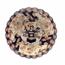 Japanese Meiji Imari porcelain fluted charger, painted in blue and iron-red with flowers, foliage and diaper patterns around a central medallion, D46cm 