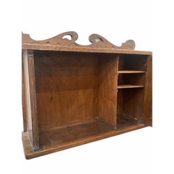 Early 20th century art nouveau period oak wall hanging cabinet, with stylised floral carving, two bevelled oval mirrors to door enclosing shelves W56cm 