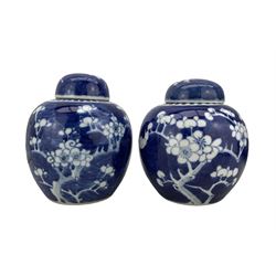 Matched pair of Chinese Prunus pattern ginger jars and covers, double ring marks beneath, H16cm & H15cm (2)