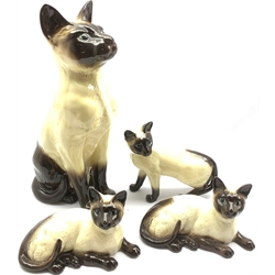 Beswick Fireside model of a Siamese cat No. 2139, pair of Siamese cats No. 1559 second version and a standing Siamese cat No. 1897 (4)
