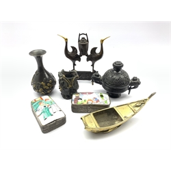 Chinese black composition two-handled censer, two 20th century Chinese white metal boxes with enamelled covers,  Japanese polished brass censer in the form of a boat, L24cm, Bronzed model of two Cranes supporting a basket together with two Oriental cast metal vases (7) 