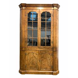 George II style figured walnut floor standing corner cabinet, two glazed doors enclosing three shaped shelves, with fluted pilasters and canted corners, two doors under, raised on skirted base W117cm, H189cm