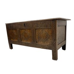 18th century oak blanket box, rectangular hinged top, frieze carved with lunettes, the three front panels decorated with lozenges, flanking uprights with stylised acanthus leaves, raised on stile supports