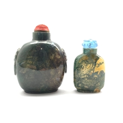 Chinese moss agate style snuff bottle with ring handles and cinnabar stopper, H8cm together with a similar smaller snuff bottle with blue glass stopper (2)