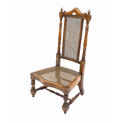 Late 19th century walnut hall chair, arched and scrolled crest rail over turned uprights, bergere seat and back panels, and raised on turned front supports with 'H' stretcher 