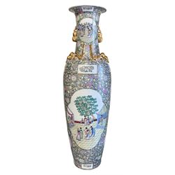 Large Chinese twin-handled Famille Rose floor vase, decorated with panels of figures in a courtyard setting against a profusely enamelled and gilded ground with fruit, flowers and foliage, H182cm