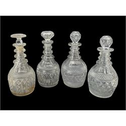 Pair of Georgian Prussian bodied triple ring neck decanters with slice and diamond cut decoration, H27cm, together with another pair of Georgian cut glass decanters, one lacking stopper 