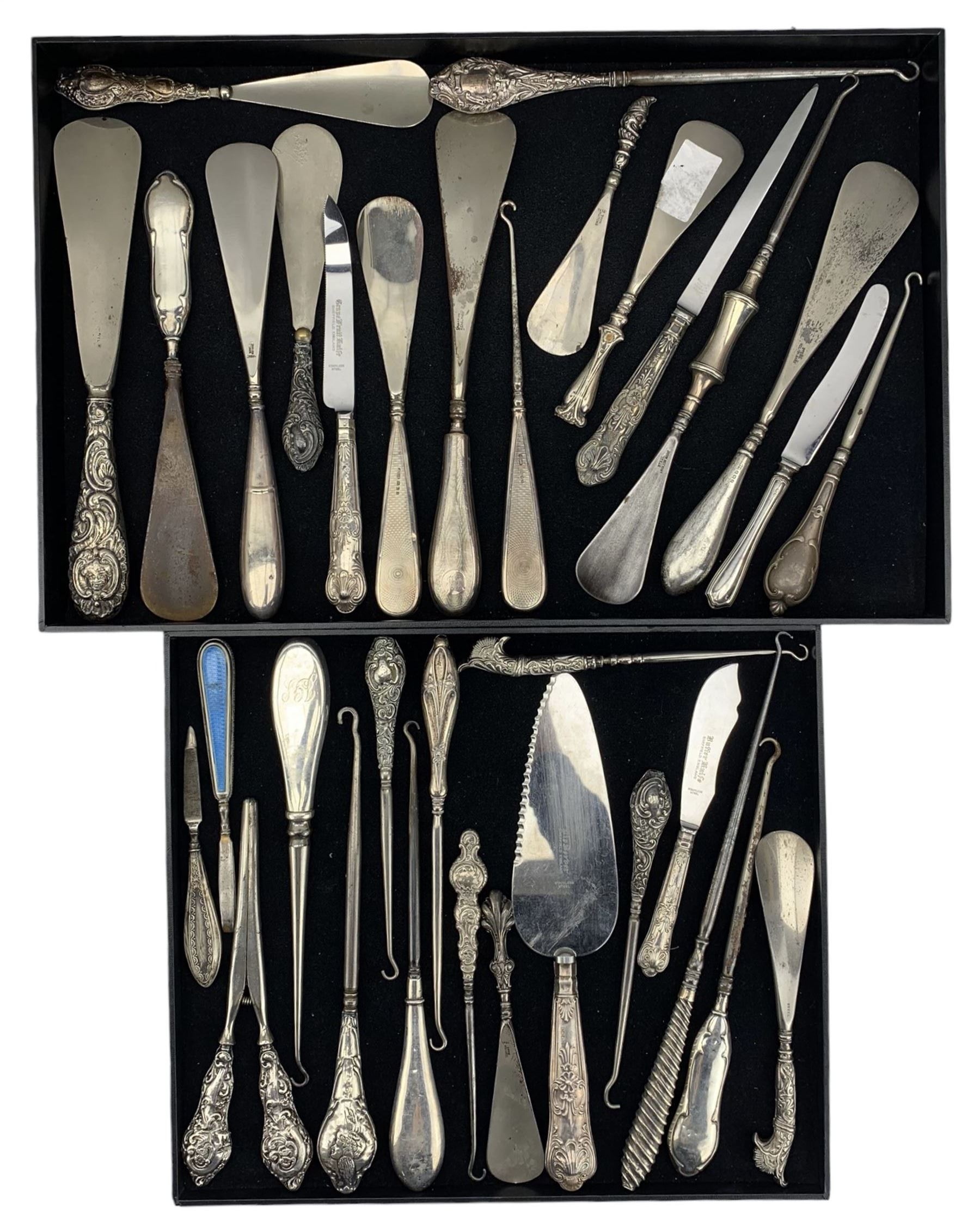 DS Victorian and later silver handled shoe horns, button hooks, glove  stretchers and similar articles including a pair of guilloche enamel and  silver handled tweezers, shoe horn with terminal depictin - The