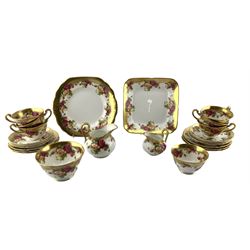 Royal Chelsea Golden Rose pattern tea set for six comprising six teacups, saucers and tea plates, two sugar bowls, two milk jugs, square and rounded serving plates