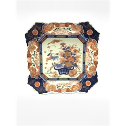 Japanese Meiji period Imari charger of canted square form, painted with a basket of flowers within a panelled border, 32cm x 32cm 