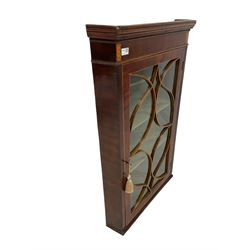 George III mahogany corner wall cabinet, the glazed door of tracery design enclosing three fixed shelves 