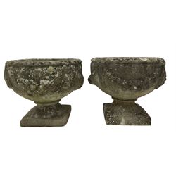 Near pair of garden urns with swags, raised on bases of square form