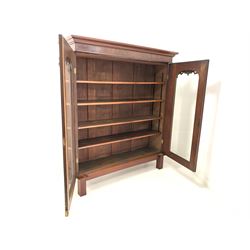 Late Victorian mahogany display cabinet bookcase, projecting cornice over two arched glazed doors with leaf carved corbels and applied floral moulding, enclosing four adjustable shelves, raised on square fluted supports, Formerly the top section of a bookcase on cupboard. W151cm, D47cm