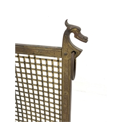 Early 20th century gilt metal spark guard, with brass grill and dragon finials, raised on scrolled supports, W74cm