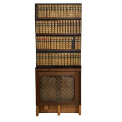 19th century secret door disguised as a bookcase, painted pine panelled door lined on one side with leather book spines over mahogany and glazed bookcase door with gilt metal grille (83cm x 201cm); a half panelled door lined with book spines to one side (83cm x 112cm); and two small mahogany bookcase doors with glass panes and gilt metal grilles (52cm x 61cm)