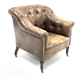  George Smith leather club chair, upholstered in deep buttoned leather, raised on turned walnut front supports and brass castors, W84cm  