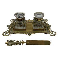 Victorian pierced brass desk stand with twin glass inkwells and associated brass letter knife, L27cm 