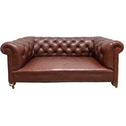 Leather Chesterfield style settee, upholstered in buttoned back brown leather, raised on ceramic castors 