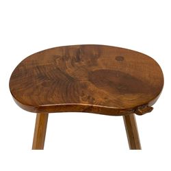 Beaverman - oak four-legged stool or occasional table, figured shaped top carved with beaver signature, on octagonal tapered supports, by Colin Almack of Sutton-under-Whitestone Cliffe