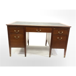 20th century mahogany twin pedestal desk, skivered top over one long drawer, two skivered slides and four short drawers, raised on square tapered supports terminating in brass cups, 138cm x 76cm, H76cm