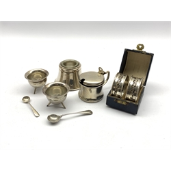 Pair of pierced silver serviette rings with key pattern decoration Birmingham 1929, boxed, circular silver mustard pot Birmingham 1933, pair of Edwardian silver cauldron shape salts and a silver inkwell with glass liner approx 4.6oz