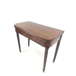 William IV mahogany fold over tea table, with ebonised string inlay, raised on turned reeded supports W90cm