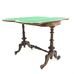Victorian walnut serpentine card table, the fold over revolving top revealing storage well, birds eye maple and rosewood veneer and a baize lined playing surface, raised on two ring turned end supports with relief carved floral decoration united by stretcher, over four scroll carved splayed supports terminating in ceramic castors, 95cm x 50cm, H78cm