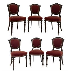 Set six late 19th century carved walnut dining chairs, foliate cresting flanked by carved ribbon decoration, over upholstered back and seat, raised on fluted turned supports 
