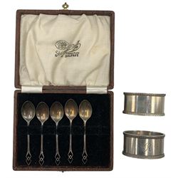 Pair of heavy silver oval napkin rings, monogrammed, H F Withers, Birmingham 1965, and a set of five silver coffee spoons 