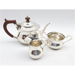 Silver three piece tea set of circular form, the teapot with stained handle and lift Birmingham 1939 Maker S Blanckensee & Son Ltd 18.9oz