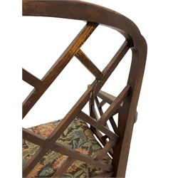 George III Chinese Chippendale 'Cockpen' design elbow chair, stepped arch cresting rail over cockpen back, shaped arms with scrolled terminals, with floral needlework seat, on square supports united by H stretchers