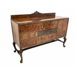 20th century Queen Anne style walnut sideboard, the raised back surmounted with carved pediment over top with moulded edge, three short drawers flanked by two cupboard doors under, raised on cabriole supports united by stretcher 