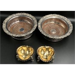 Pair of Victorian silver-plated trifom salts, gilt interior with scalloped rim, raised on Phoenix suppors, W7cm together with a pair of silver-plated bottle coasters with turned base and acanthus moulded borders (4)
