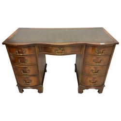 Georgian design mahogany two pedestal desk, serpentine top with inset leather, fitted with nine drawers, on bracket feet