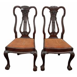 Pair of mahogany lyre back dining chairs with drop in upholstered seat pads and ball and claw front supports 