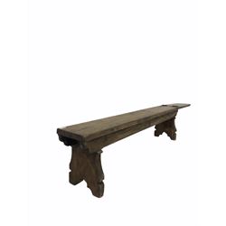 19th century pine bench, raised on shaped panel end supports, the hinged section formally leading to another bench, lifting to create aisle L155cm