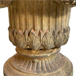 19th century two-piece terracotta garden planter, decorated with laurel leaf festoons held by mythical beast masks, fluted body moulded with leaves, on circular fluted footed base