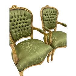 Pair French style gilt wood bedroom chairs, the cresting rail carved with flower heads, upholstered in buttoned green fabric, on cabriole supports